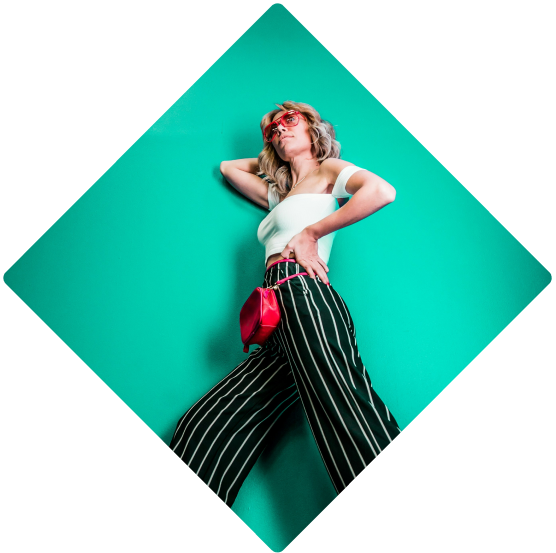 a woman in a white top and black and white striped pants